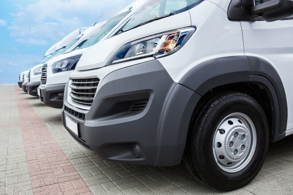 fleet of white commercial vehicles